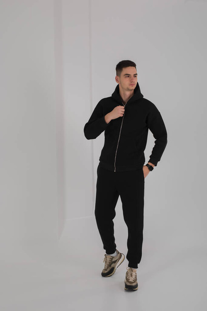 Man posing in studio wearing black hoodie costumes - Valokuva, kuva