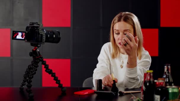 European woman blogger includes a camera to blog about makeup and beauty. - Footage, Video