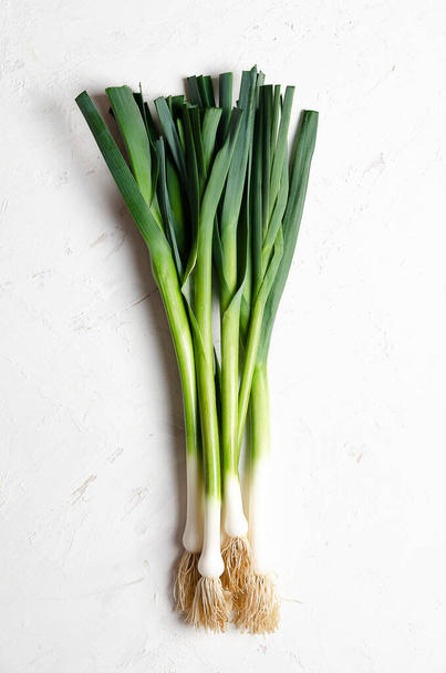 A bunch of fresh leeks on a white background.  - Photo, image