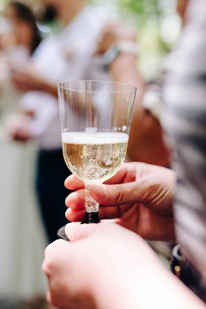 the bride holds a glass of delicious champagne - Photo, Image