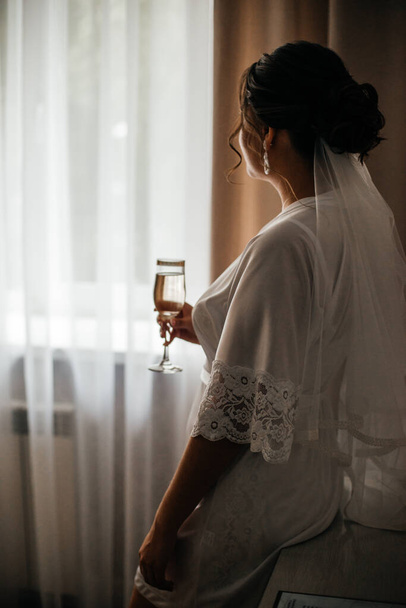 the bride holds a glass of delicious champagne - Foto, afbeelding