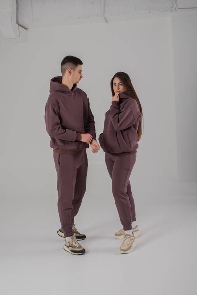 Couple posing in studio wearing brown hoodie costumes - Foto, Imagen