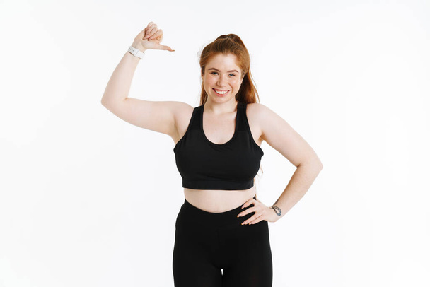 Young ginger woman smiling while pointing finger at herself isolated over white background - Foto, immagini