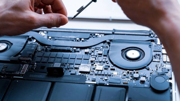Computer motherboard. Pc technician repair service with laptop on hardware technology background. Maintenance engineer support. Developer soldering electronic component - Photo, Image