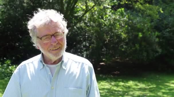 Older Man Smiling In Park - Filmati, video