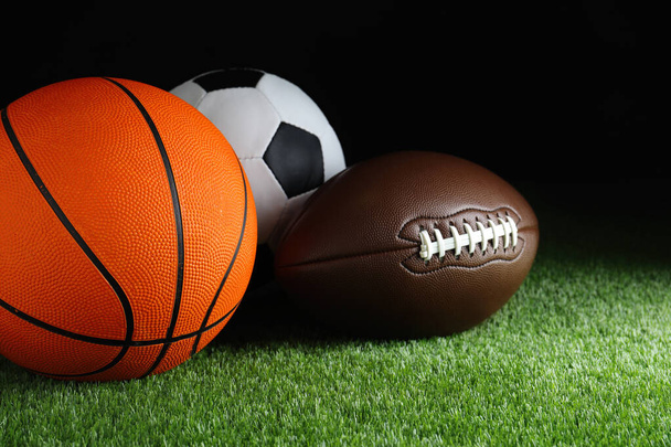 Set of different sport balls on green grass - Foto, imagen