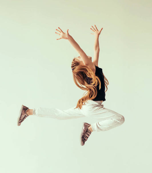 Girl doing leaping in the air - Фото, изображение