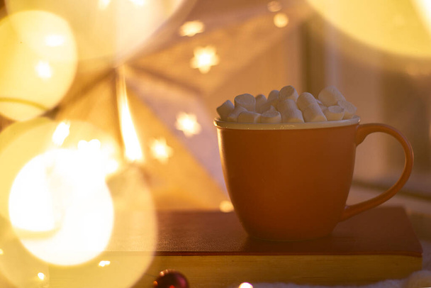Huiselijke gezellige sfeer Kerstmis. Rode mok met marshmallows. Bokeh. Kopieerruimte - Foto, afbeelding