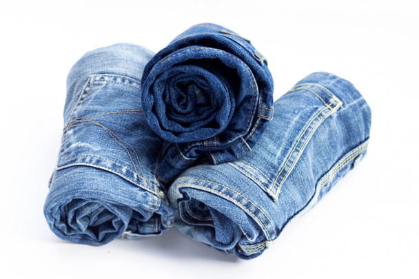 Rolled blue jeans on white background - Photo, Image