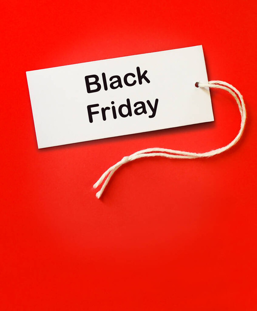 Black friday sale tag on bright red background. White label black friday clothes discount attention. - Fotó, kép