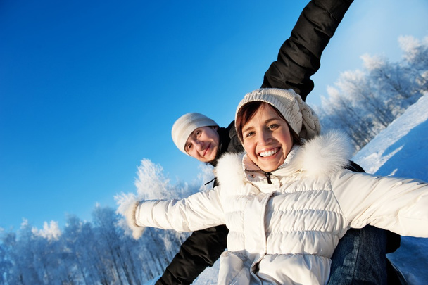Happy smiling couple on a winter background - Photo, Image