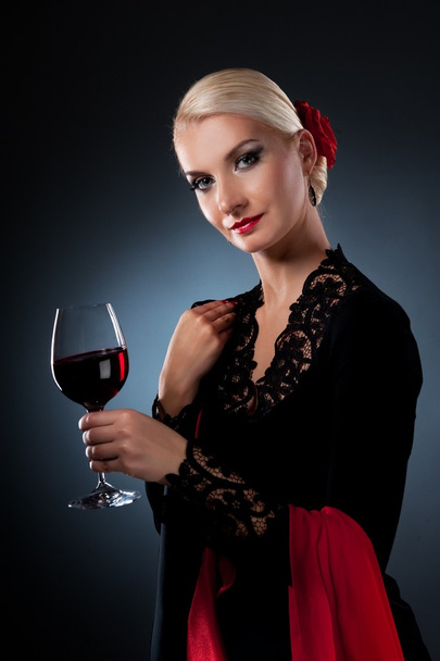 Beautiful flamenco dancer holding a glass of wine - Zdjęcie, obraz