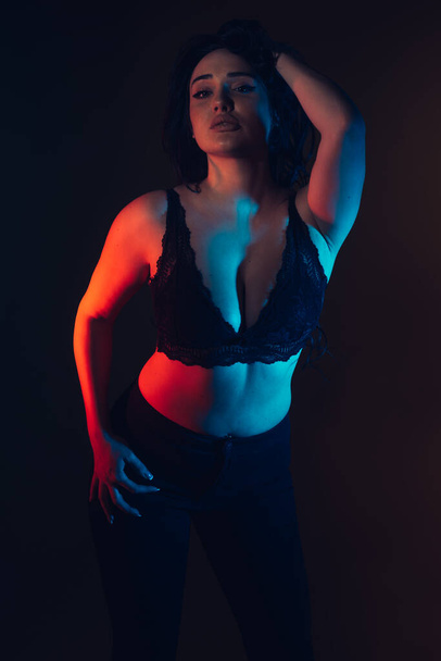 Plus size sexy fashion model in lingerie, fat woman with big natural breast lying on black studio background, overweight female body - Zdjęcie, obraz