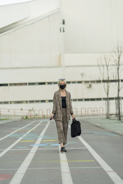 Businesswoman walking while thinking about the company - 写真・画像