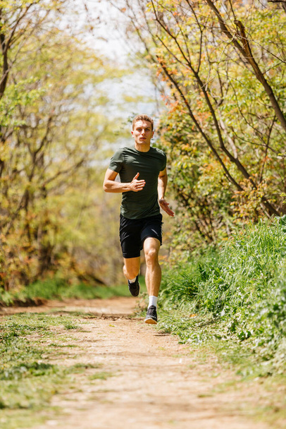 Sport man running. Portrait of runner man jogging in park. Sport workout outdoor. Athlete training run exercise - Photo, Image