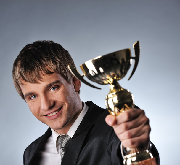 Happy businessman with a golden cup - Foto, Bild