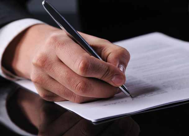 Businessman writing on a form - Photo, Image