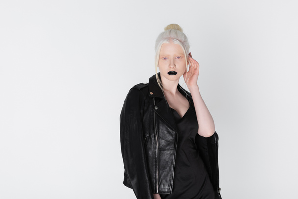 Pretty albino model in leather jacket posing isolated on white - Фото, зображення