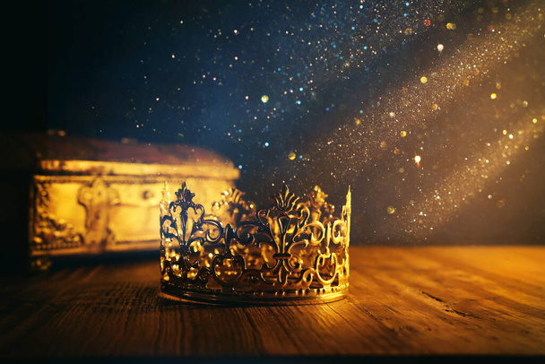 low key image of beautiful queen or king crown and gold treasure chest. vintage filtered. fantasy medieval period - Φωτογραφία, εικόνα