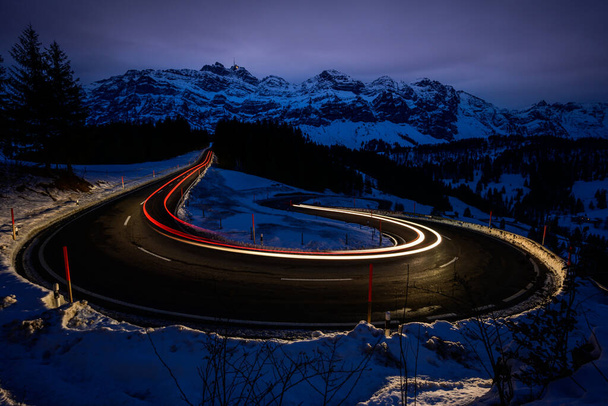 lighttrails and a curve and some mountain - Фото, изображение