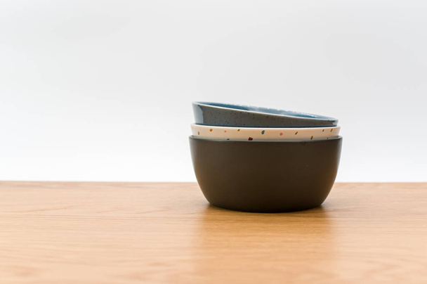 isolated earthenware bowls on a wooden background with copy space - Fotó, kép