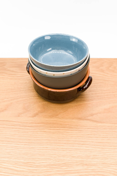 isolated earthenware bowls on a wooden background with copy space - 写真・画像