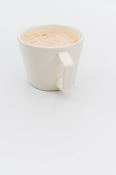 modern white stoneware cup with hot vegan Cappuccino on a white background with copy space - Foto, Imagem