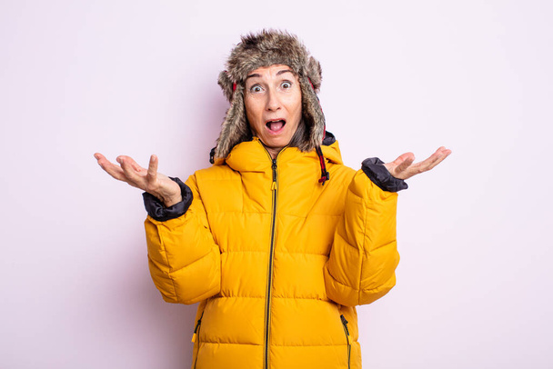 senior pretty woman feeling extremely shocked and surprised. winter concept - Foto, Bild