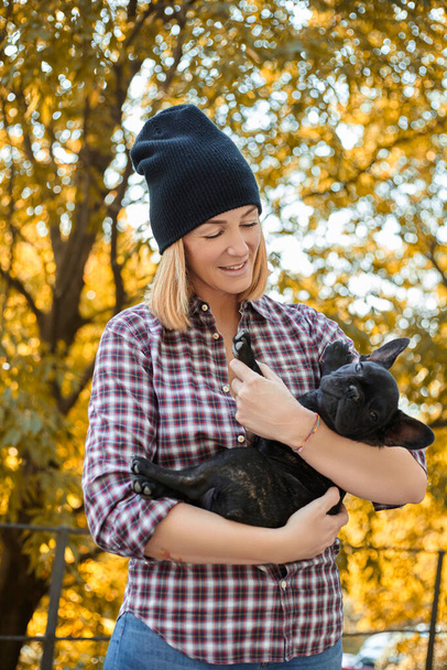 Closeup on happy young woman with dog outdoors in autumn - Foto, Bild