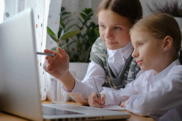 Two girls, sisters study at home, distance learning - Foto, imagen