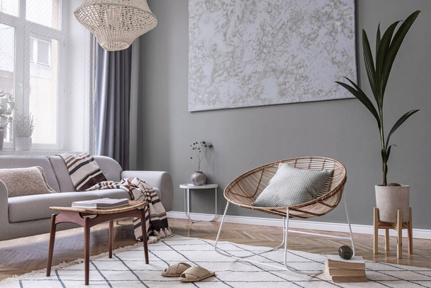 Stylish composition of creative and cozy living room interior with coffee table, rattan armchair, plants, carpet and beautiful boho accessories. Eucalyptus walls and parquet floor.  - Фото, зображення