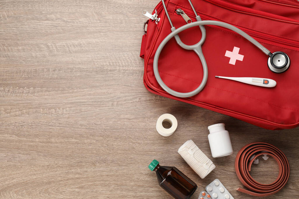 First aid kit on wooden table, flat lay. Space for text - Photo, image