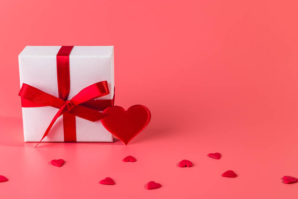 Valentine's day background with red hearts and gift. Copy space.  - Фото, зображення