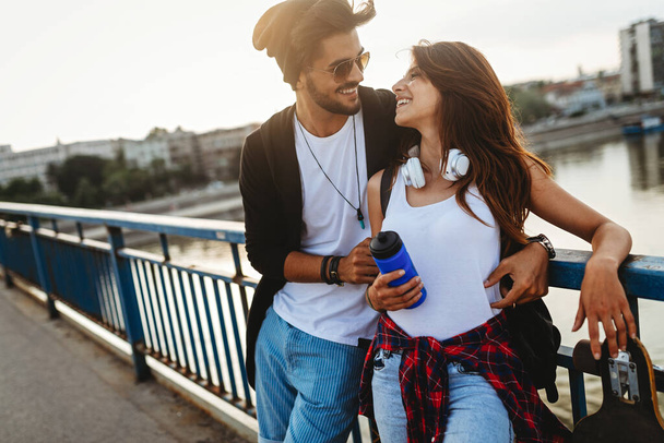 Portrait of happy young couple in love enjoying time together in city. People travel fun happiness concept - Photo, image