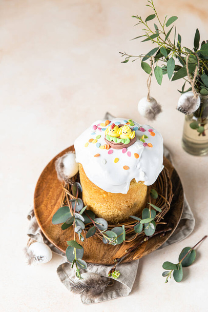 Kulich. Traditional Orthodox Easter sweet bread decorated with meringue icing and candy shaped eggs. Selective focus. - Фото, изображение