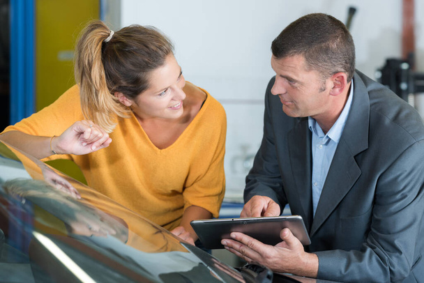 insurance agent and customer checking tablet - 写真・画像