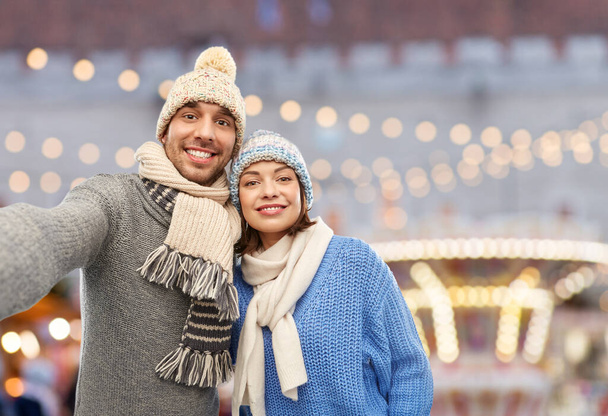 happy couple in winter clothes taking selfie - Photo, Image
