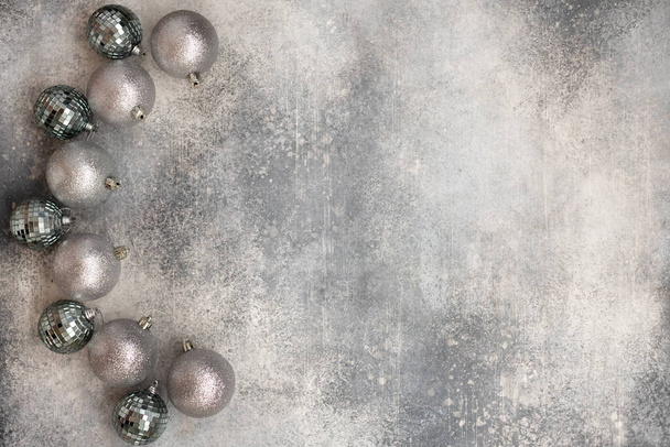 Christmas decoration with shiny silver balls on a gray background. - Фото, изображение