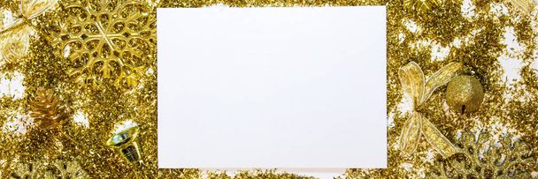 Christmas background with gifts, gold ribbon and gold Christmas decorations, glitter. Christmas background, top view. Copy space. Banner. - Photo, image
