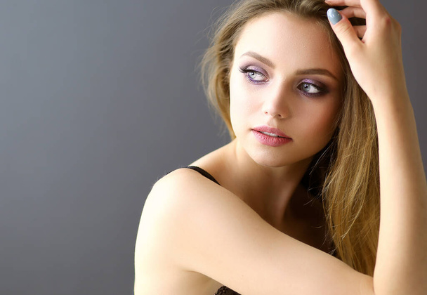 Young woman posing in sensual nightwear, looking at camera - Fotografie, Obrázek