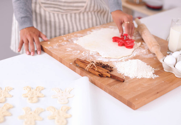 Woman making christmas cookies in the kitchen - Fotoğraf, Görsel