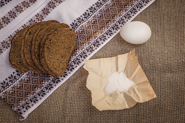 Rye bread, egg and salt on canvas - Photo, Image