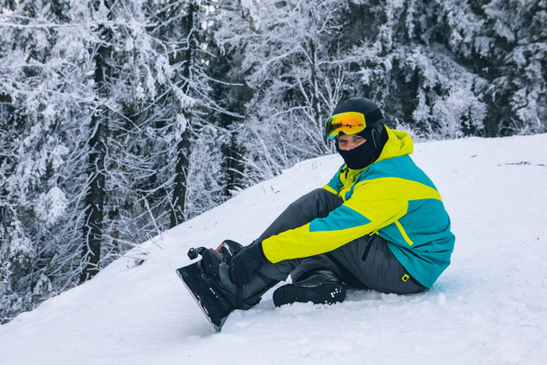 man strap in snowboard. winter sport activities. ski resort - Photo, Image
