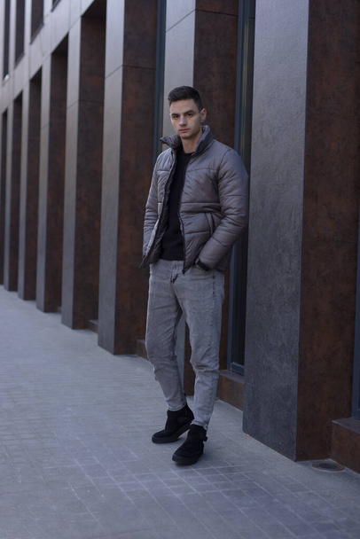 Man posing in city wearing winter jacket - Foto, Bild