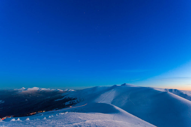 Fantastic starry sky. Winter landscape and snow-capped peaks. Carpathian mountains. Ukraine. Europe - Zdjęcie, obraz