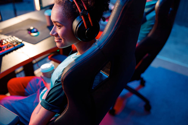 Female gamer relaxing during tournament in cyber club - Photo, Image