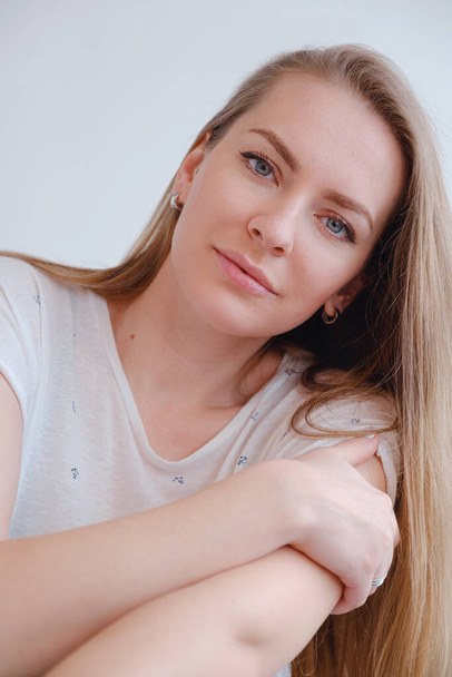 beautiful blonde young woman posing in a photo studio. - Photo, Image