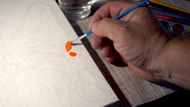 Mužská ruka s malbou štětcem s akvarely na plátně - Záběry, video