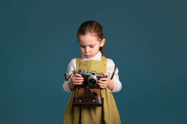 Serious cute little girl about to learn to take pictures. - Photo, Image