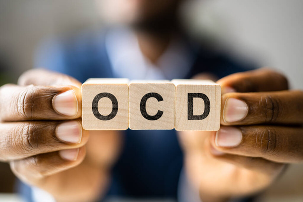 OCD Perfectionist Obsession. Perfectionist With Wooden Blocks - 写真・画像